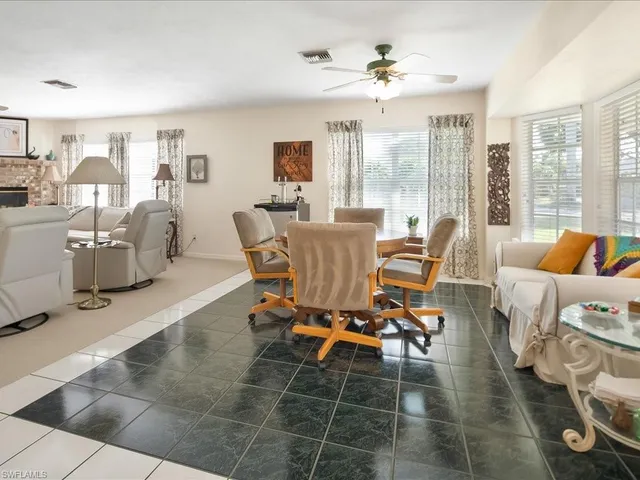 a living room with furniture and large windows