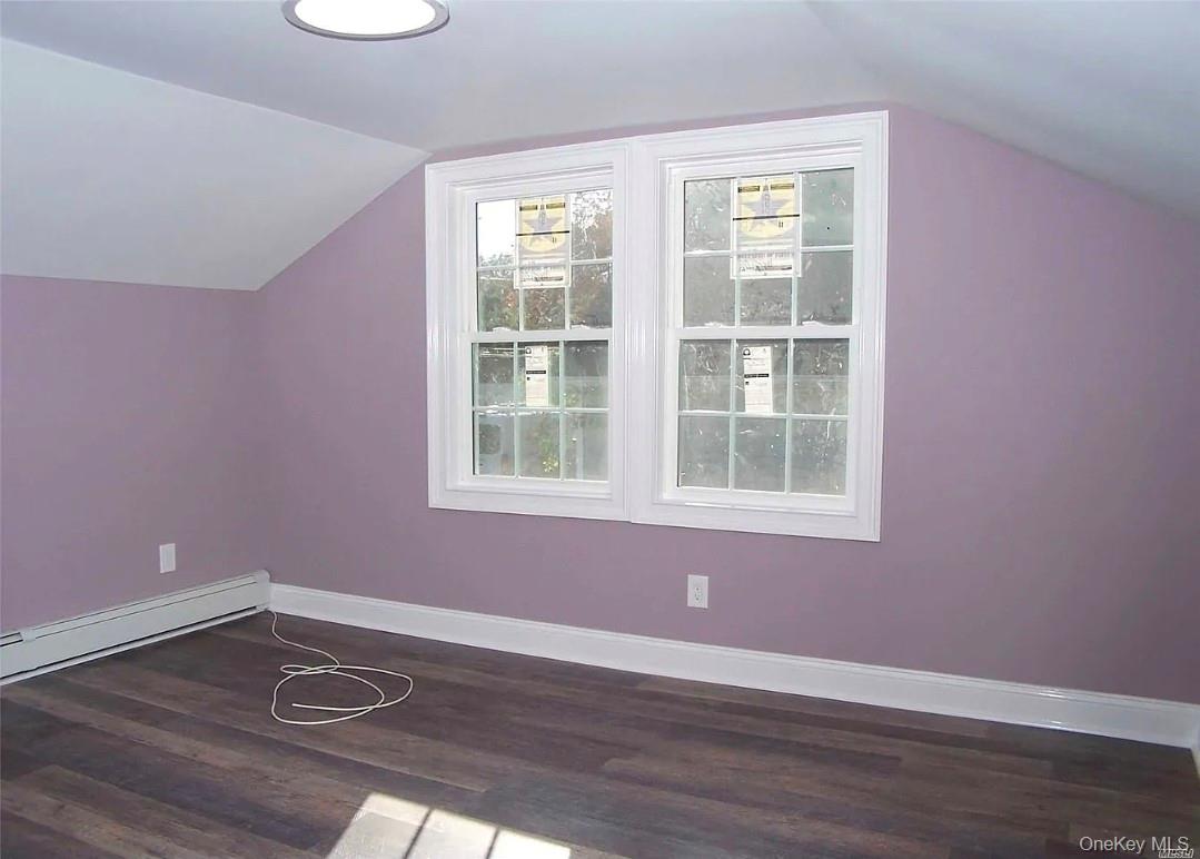 15 Ivy Road Mastic Beach, NY 11951 - Photo 13 of 24 a view of an empty room with wooden floor and a window