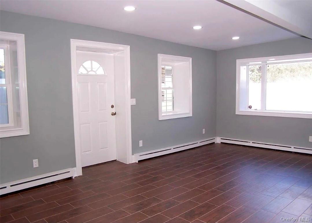 15 Ivy Road Mastic Beach, NY 11951 - Photo 14 of 24 an empty room with wooden floor and windows