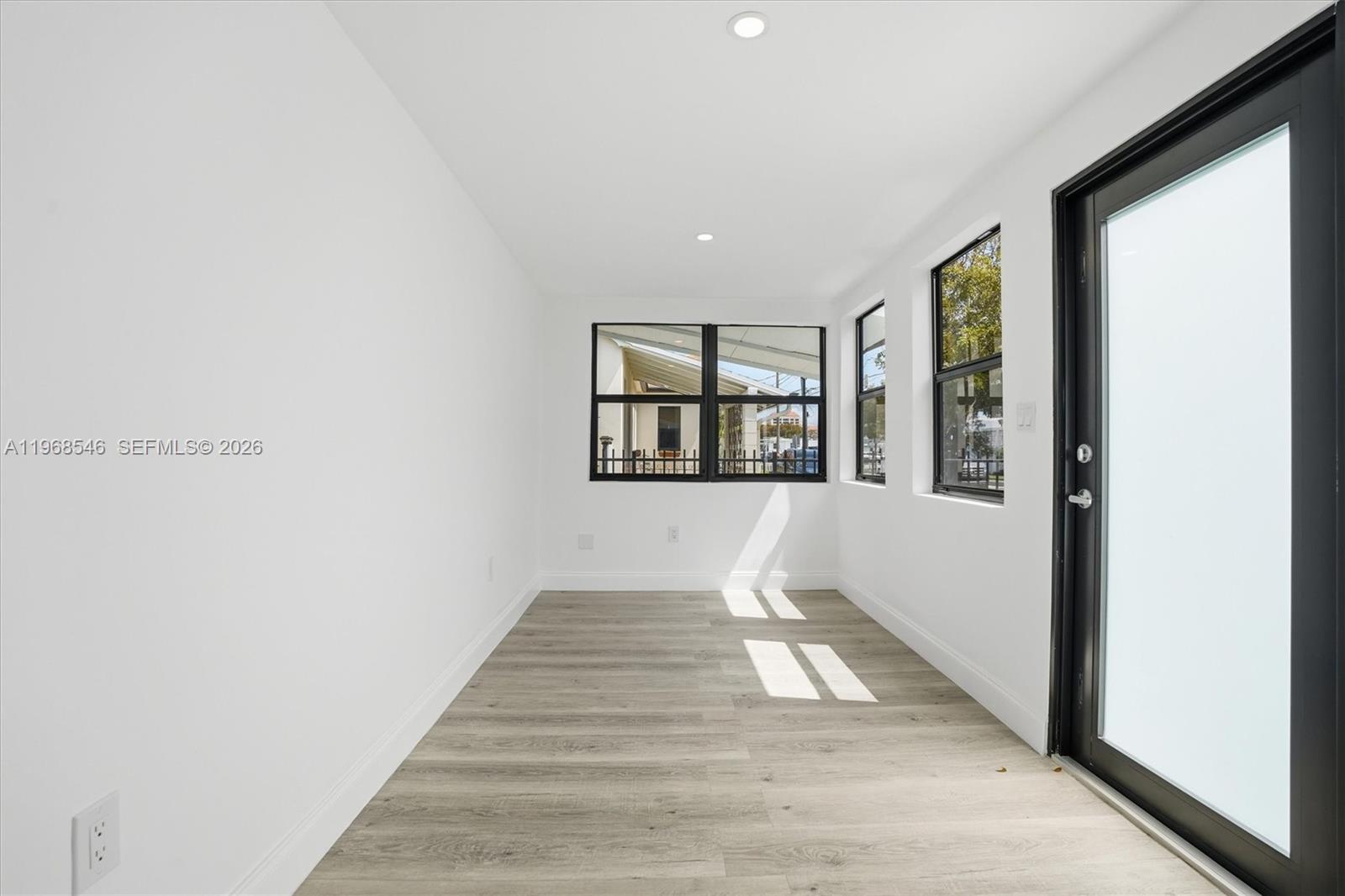 4237 Southwest 7th Street Miami, FL 33134 - Photo 5 of 31 a view of a bedroom with wooden floor and windows