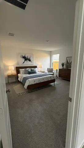 a bedroom with bed and window