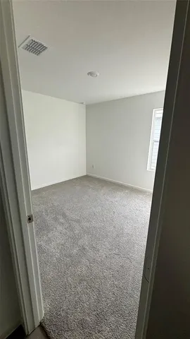 a bedroom with bed and window