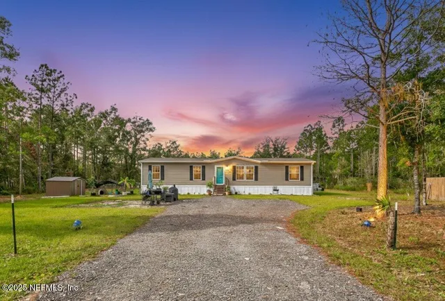 a front view of a house with a yard table and chairs