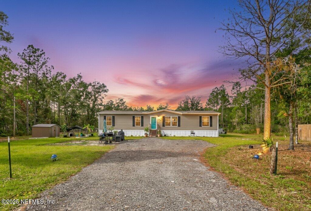 10545 Baylor Avenue Hastings, FL 32145 - Photo 1 of 17 a front view of a house with a yard table and chairs