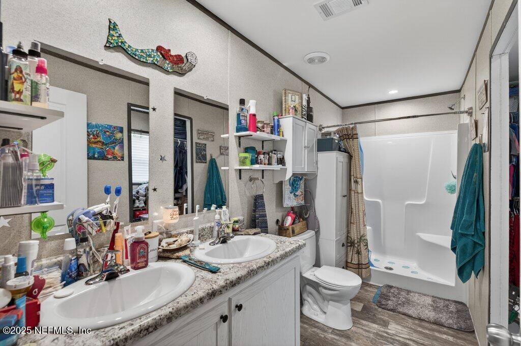 10545 Baylor Avenue Hastings, FL 32145 - Photo 11 of 17 a bathroom with a sink toilet and shower