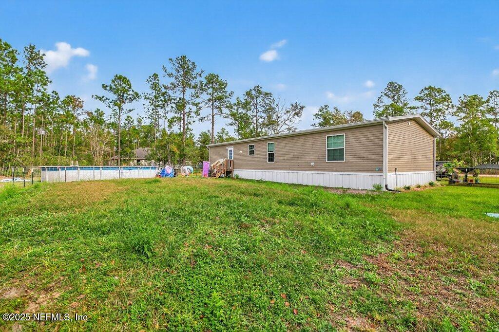 10545 Baylor Avenue Hastings, FL 32145 - Photo 12 of 17 a front view of a house with garden