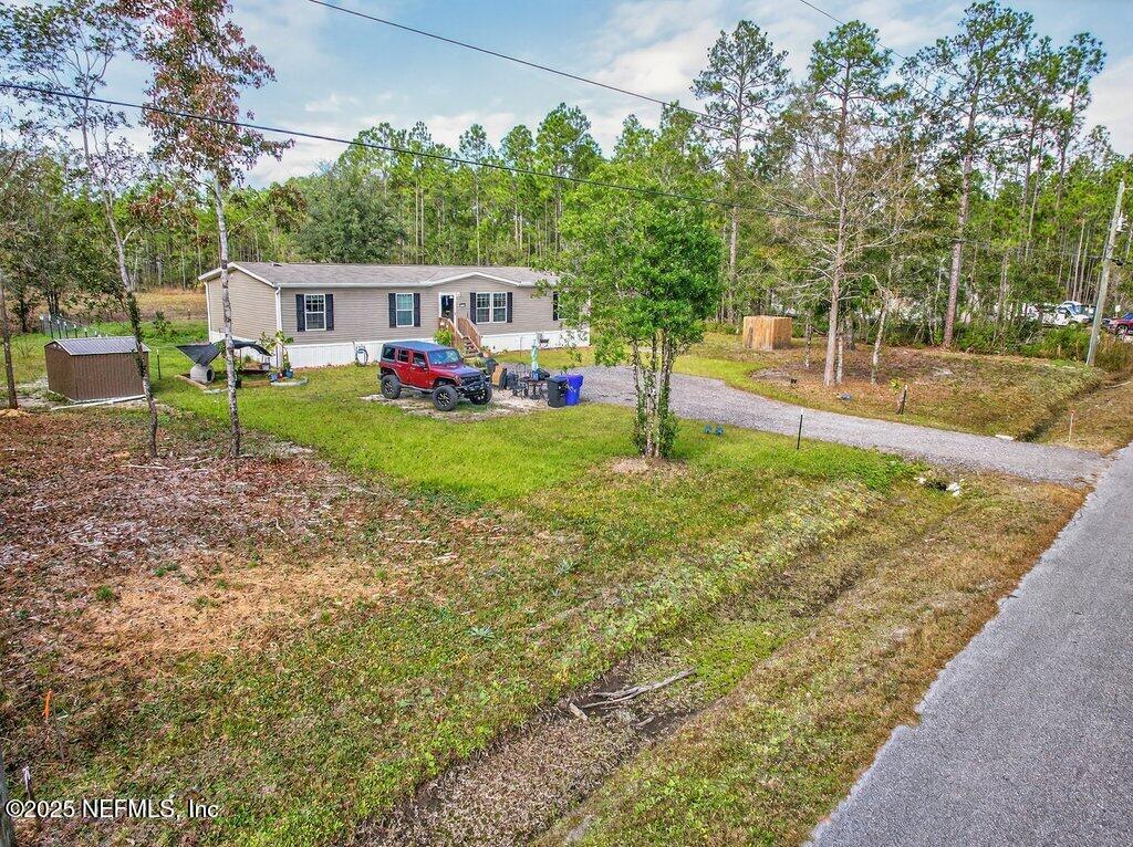10545 Baylor Avenue Hastings, FL 32145 - Photo 16 of 17 a view of a house with backyard and sitting area