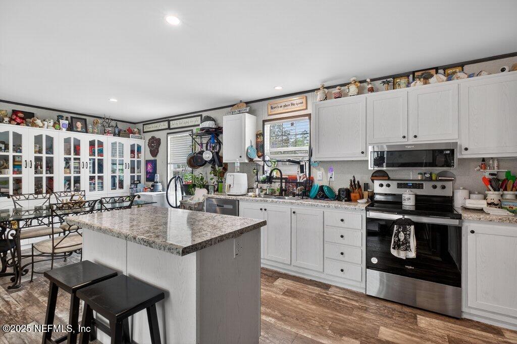 10545 Baylor Avenue Hastings, FL 32145 - Photo 8 of 17 a kitchen with stainless steel appliances granite countertop a stove a sink and a refrigerator