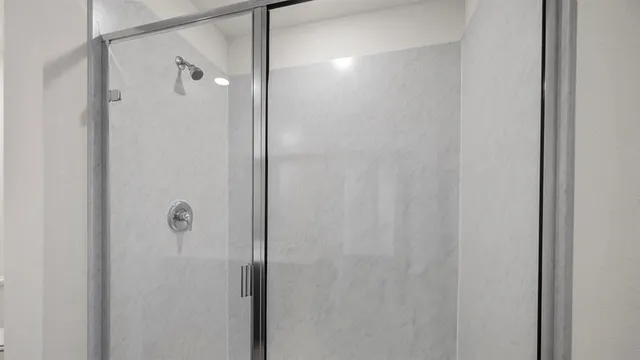 a bathroom with a glass shower door