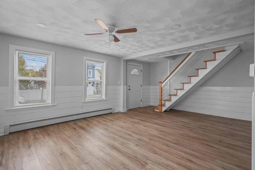 134 High Street Haverhill, MA 01832 - Photo 12 of 31 a view of an empty room with wooden floor and a window