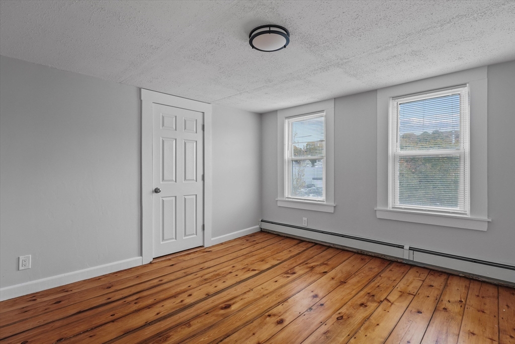 134 High Street Haverhill, MA 01832 - Photo 24 of 31 an empty room with wooden floor and windows