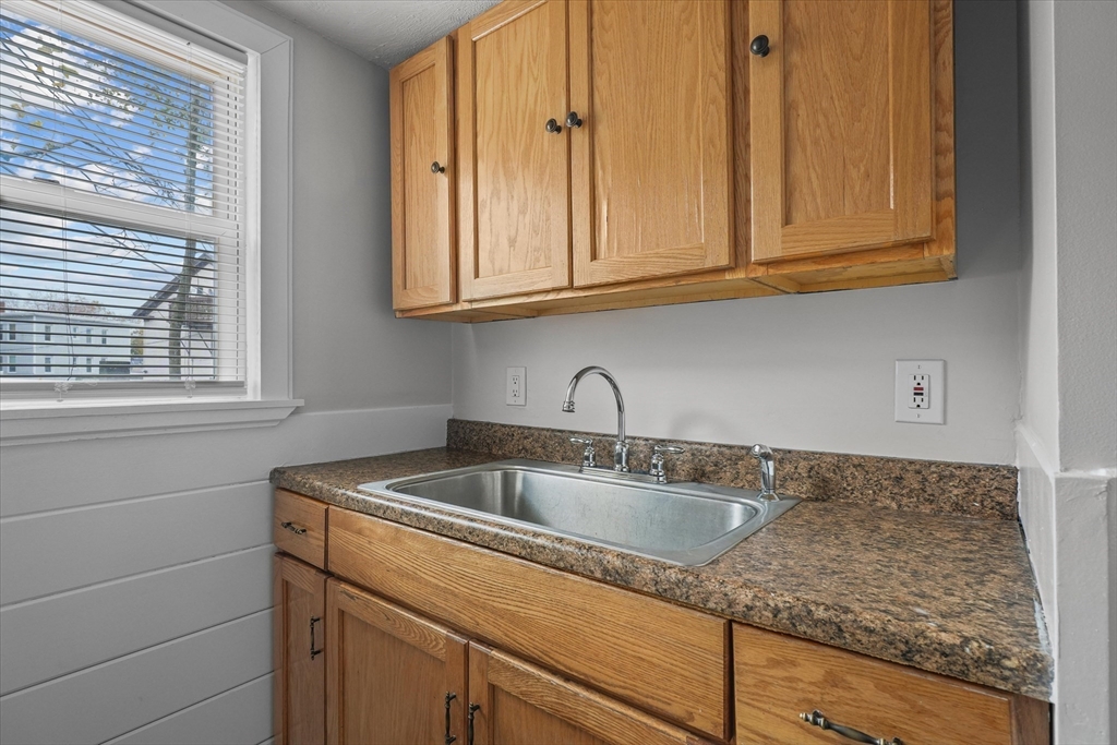 134 High Street Haverhill, MA 01832 - Photo 4 of 31 a kitchen with granite countertop white cabinets and sink