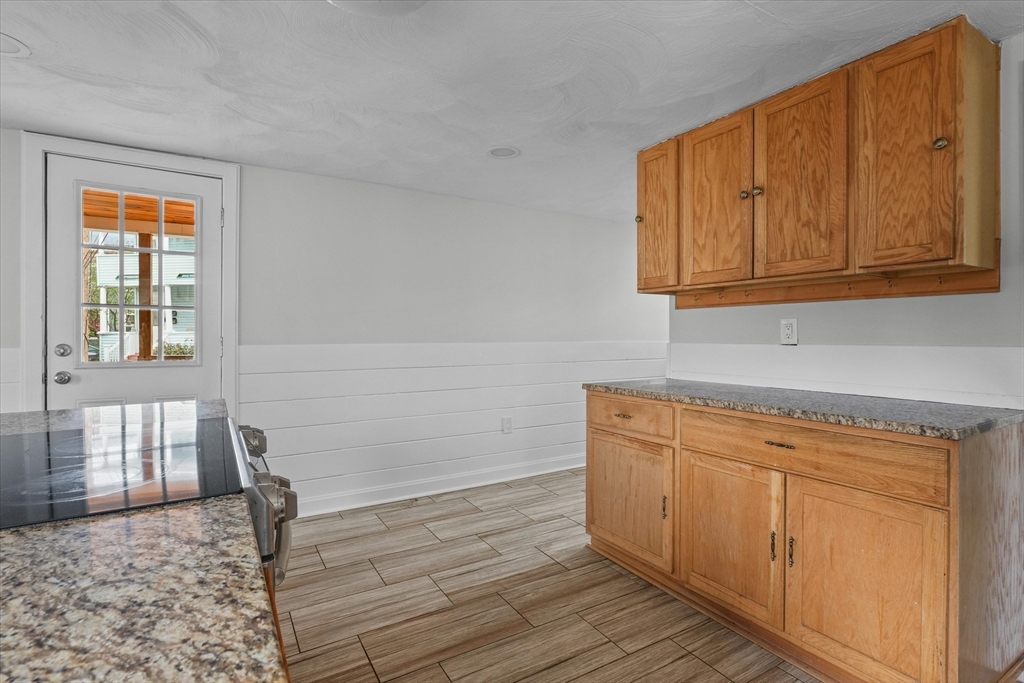134 High Street Haverhill, MA 01832 - Photo 7 of 31 a view of a kitchen with wooden floor and cabinets