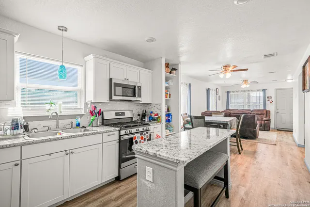 a kitchen with a sink stove and cabinets