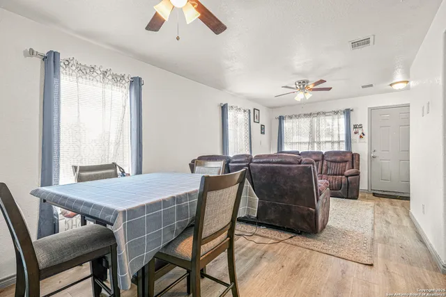 a dining room with furniture and window