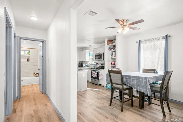 a view of a dining room with furniture and wooden floor
