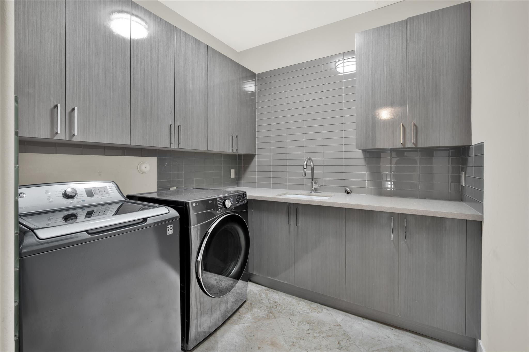 425 North Ocean Boulevard, Unit 3 Boca Raton, FL 33432 - Photo 49 of 69 a utility room with sink dryer and washer