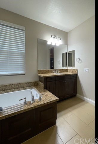 56 Shadowbrook Irvine, CA 92604 - Photo 12 of 20 a spacious bathroom with a sink double vanity and a mirror