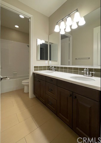 56 Shadowbrook Irvine, CA 92604 - Photo 16 of 20 a bathroom with a double vanity sink and a mirror