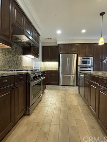 56 Shadowbrook Irvine, CA 92604 - Photo 4 of 20 a kitchen with stainless steel appliances granite countertop a stove a sink and a refrigerator