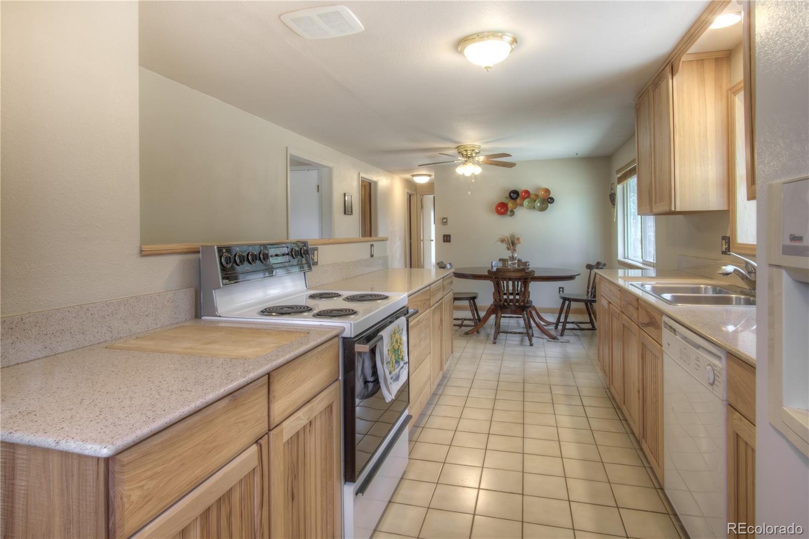 253 Raven Drive Bailey, CO 80421 - Photo 11 of 40 a kitchen with a sink stove and cabinets