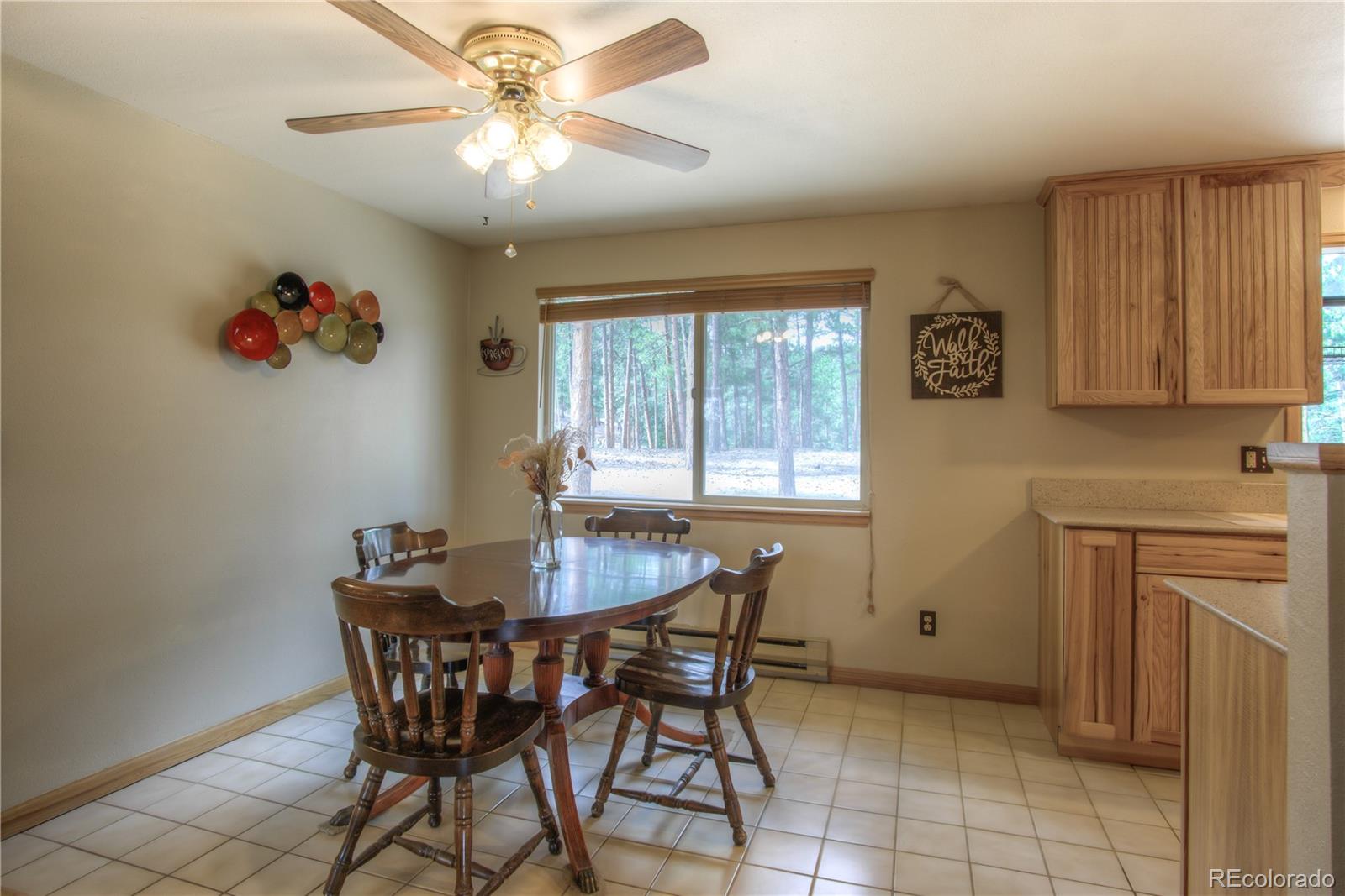 253 Raven Drive Bailey, CO 80421 - Photo 12 of 40 a dining room with furniture and window