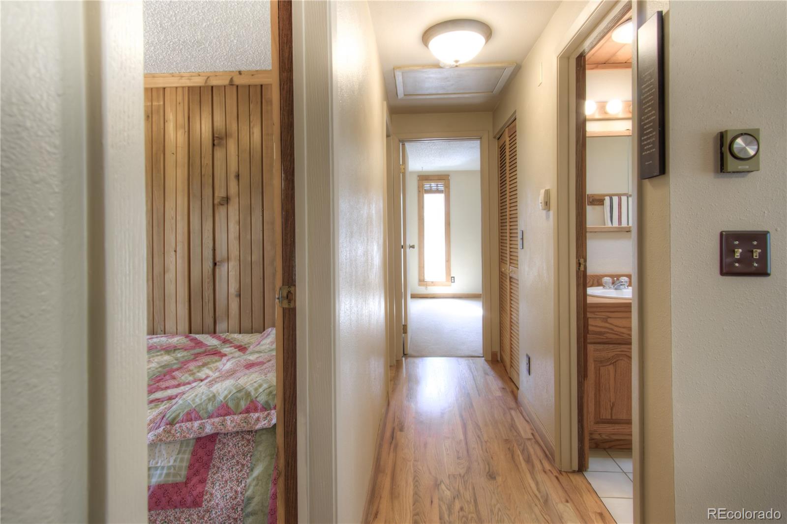 253 Raven Drive Bailey, CO 80421 - Photo 13 of 40 a view of a bathroom with a wooden door