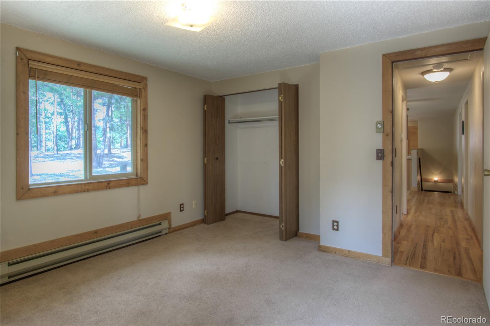 253 Raven Drive Bailey, CO 80421 - Photo 20 of 40 a view of an empty room with window and a livingroom