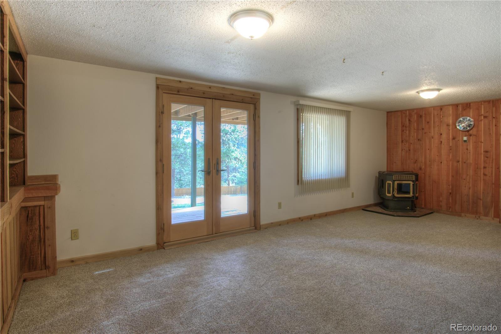 253 Raven Drive Bailey, CO 80421 - Photo 23 of 40 an empty room with furniture and windows