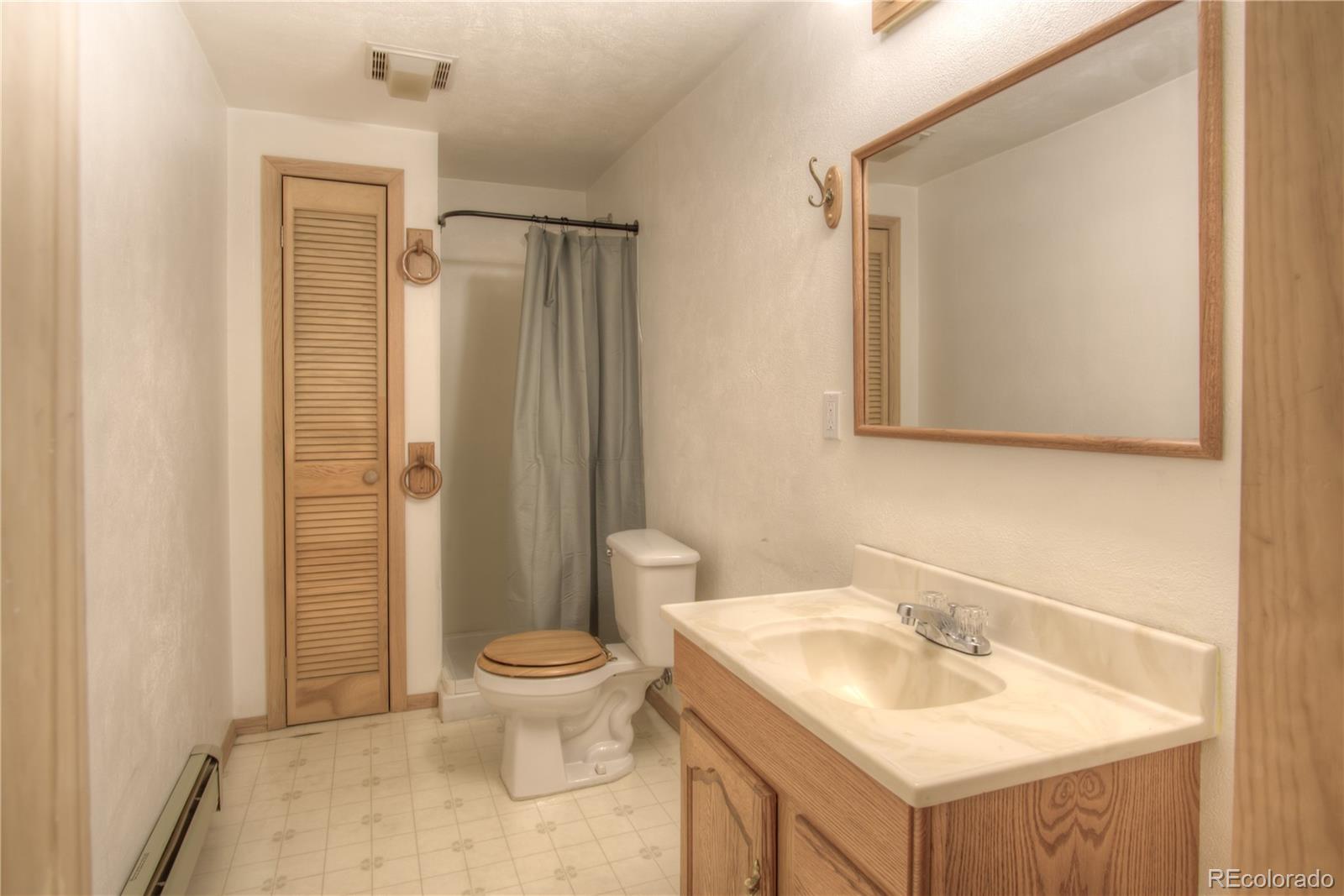 253 Raven Drive Bailey, CO 80421 - Photo 24 of 40 a bathroom with a sink toilet and shower