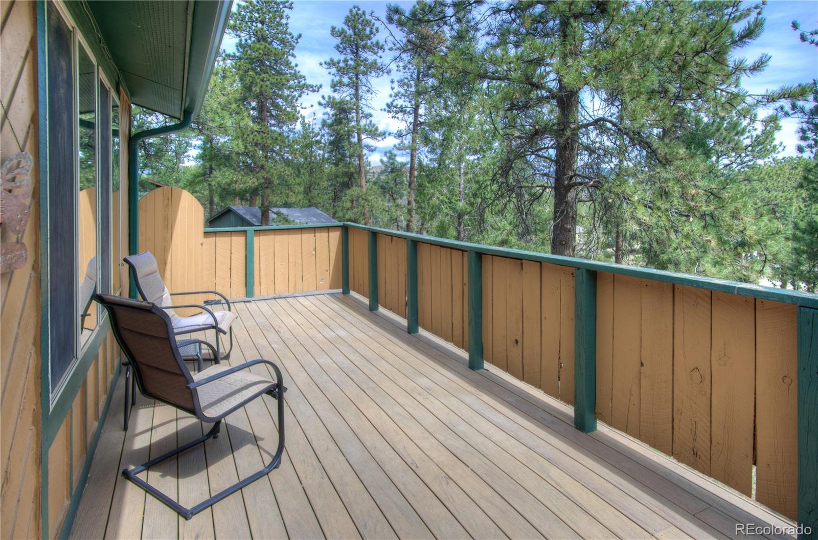 253 Raven Drive Bailey, CO 80421 - Photo 3 of 40 a view of balcony with wooden floor and outdoor seating