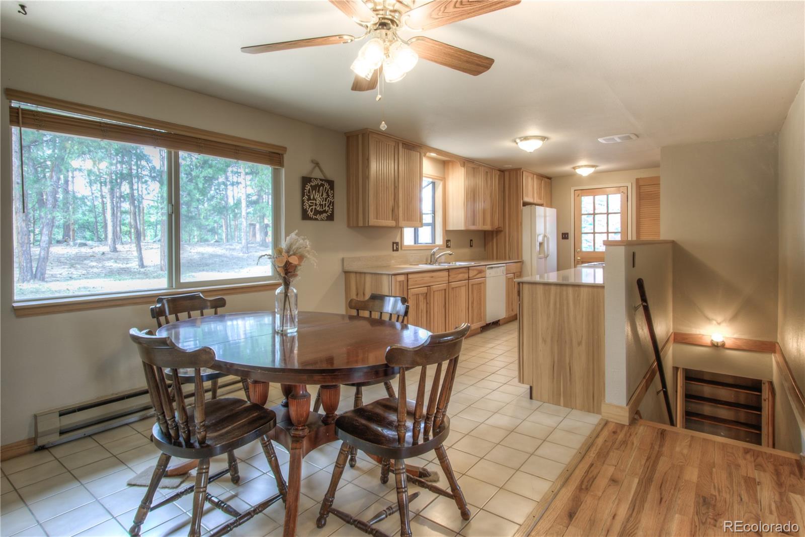 253 Raven Drive Bailey, CO 80421 - Photo 6 of 40 a view of a dining room with furniture window and wooden floor