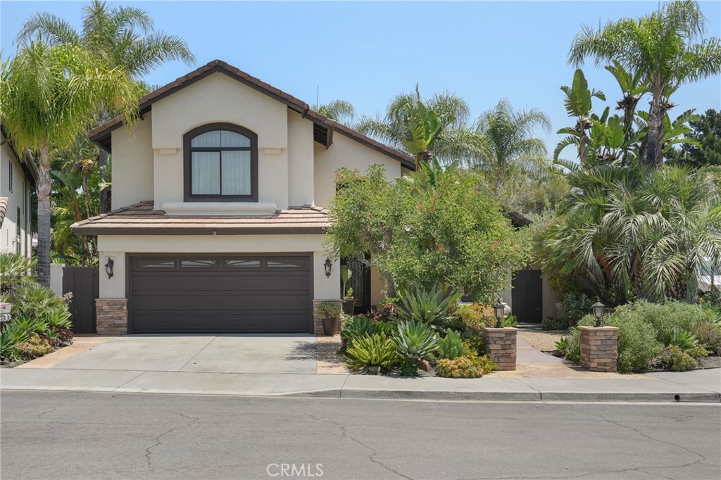 19066 Willow Brook Lane Lake Forest, CA 92679 - Photo 2 of 41 a front view of a house with a yard and garage