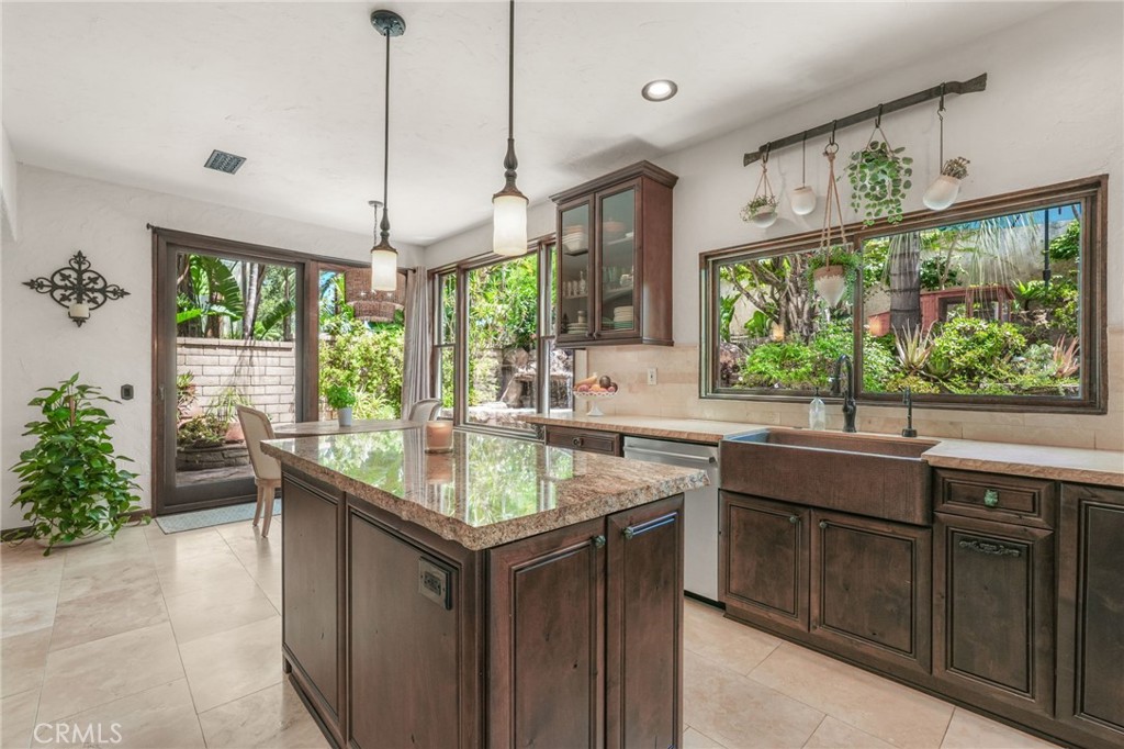19066 Willow Brook Lane Lake Forest, CA 92679 - Photo 7 of 41 a kitchen with kitchen island granite countertop a sink and a large window