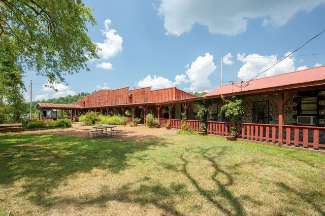 a view of a house with swimming pool and porch with furniture