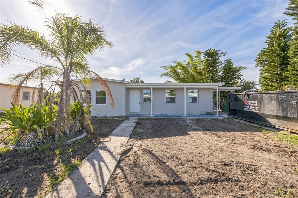 175 Rodgers Avenue Northeast Port Charlotte, FL 33952 - Photo 1 of 1 a front view of a house with a yard and potted plants