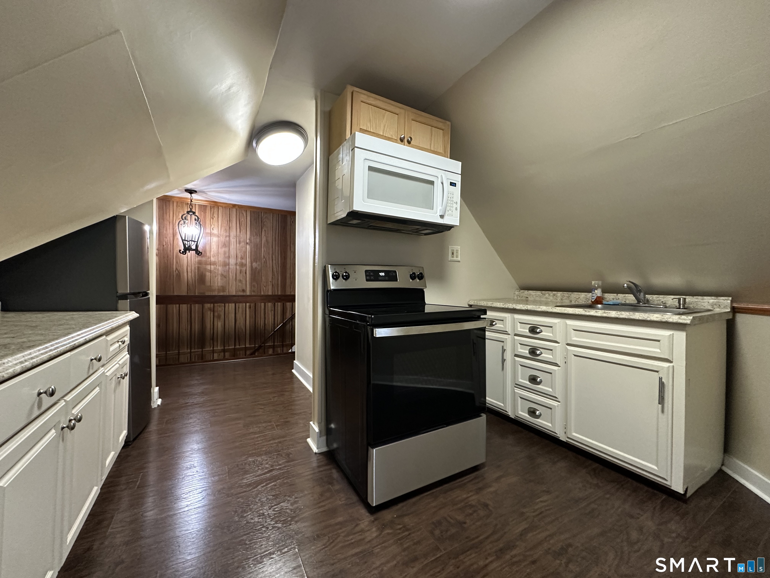 11 West Street New London, CT 06320 - Photo 12 of 24 a kitchen with a stove and a refrigerator