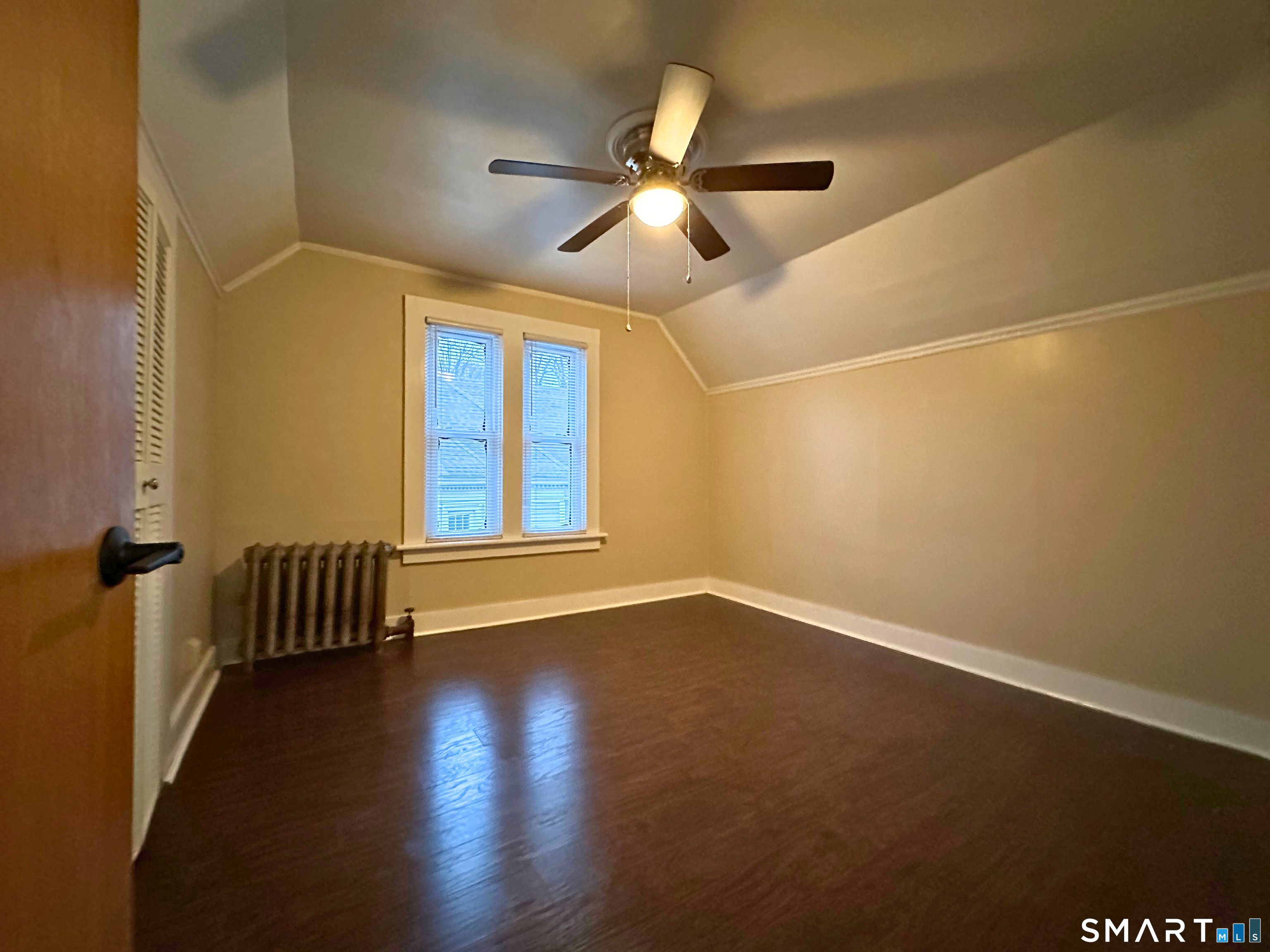 11 West Street New London, CT 06320 - Photo 18 of 24 an empty room with wooden floor fan and windows