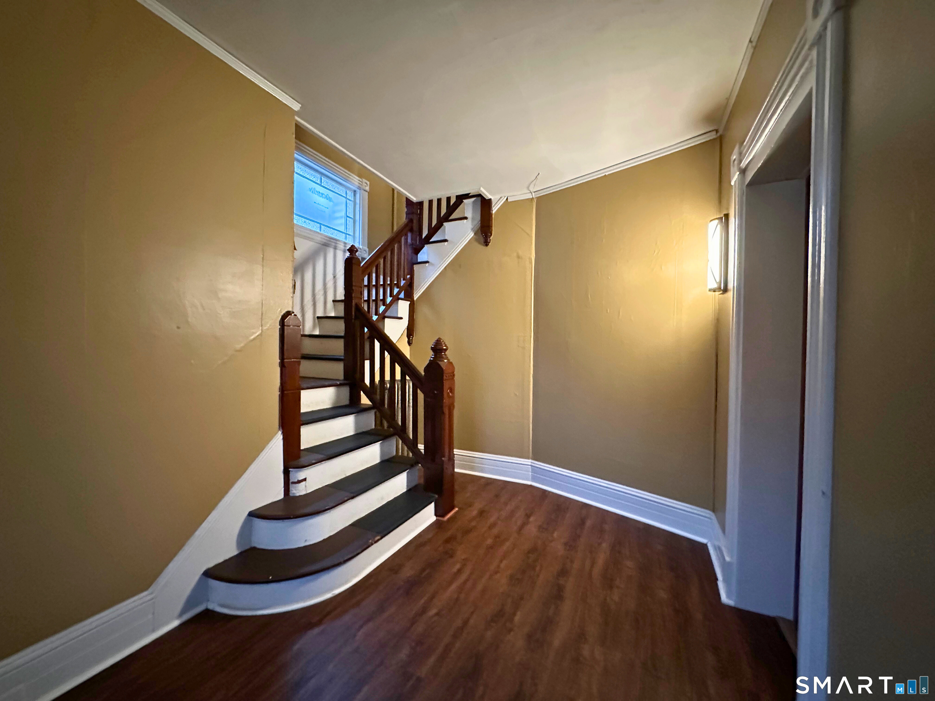 11 West Street New London, CT 06320 - Photo 2 of 24 a view of entryway with stairs and wooden floor