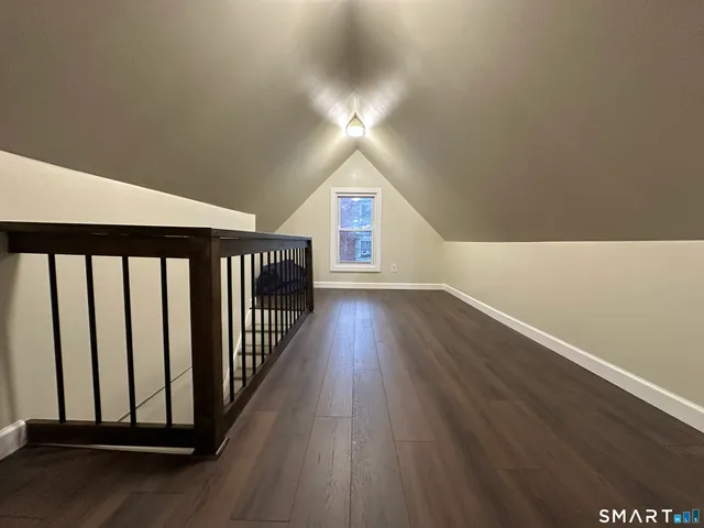 a view of a room with wooden floor and windows
