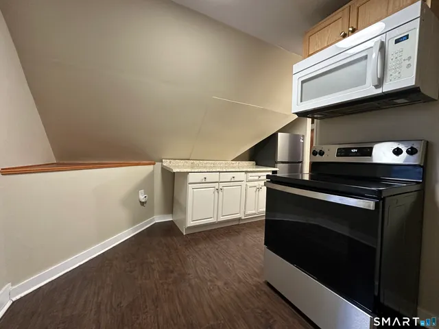 a kitchen with a stove and a refrigerator