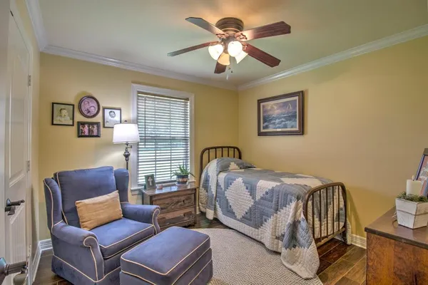 a bedroom with a bed couch and a window