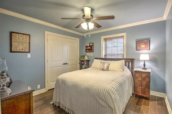 a bedroom with a bed and a chandelier
