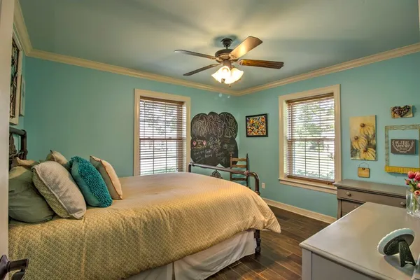 a bedroom with a bed and a chandelier