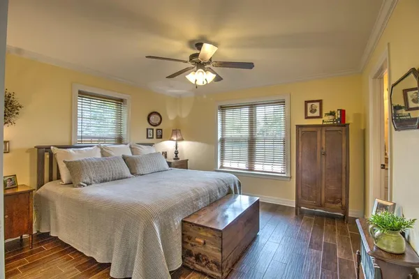 a bedroom with a bed and wooden floor