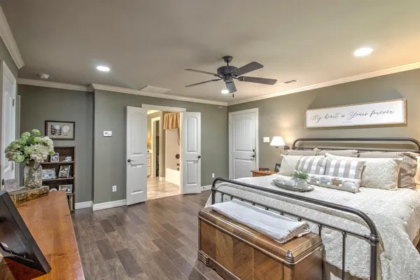 a bedroom with a bed and ceiling fan