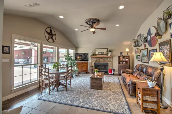 a living room with furniture fireplace and flat screen tv