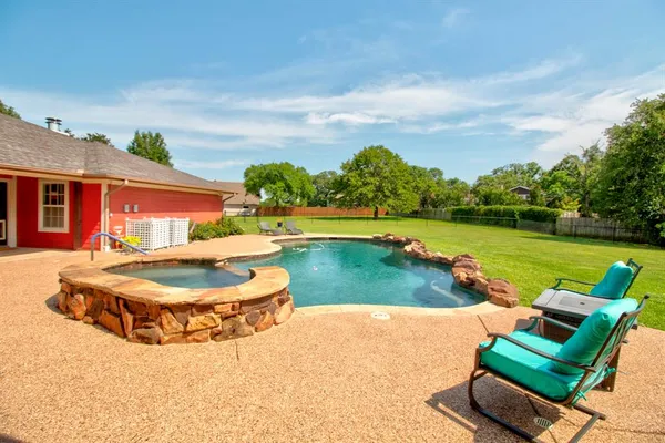 an outdoor space with patio and swimming pool