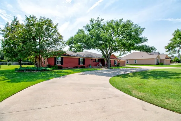 a front view of house with yard and green space