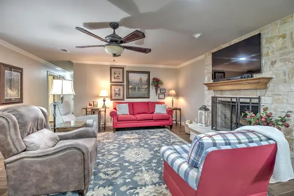 a living room with furniture a flat screen tv and a fireplace